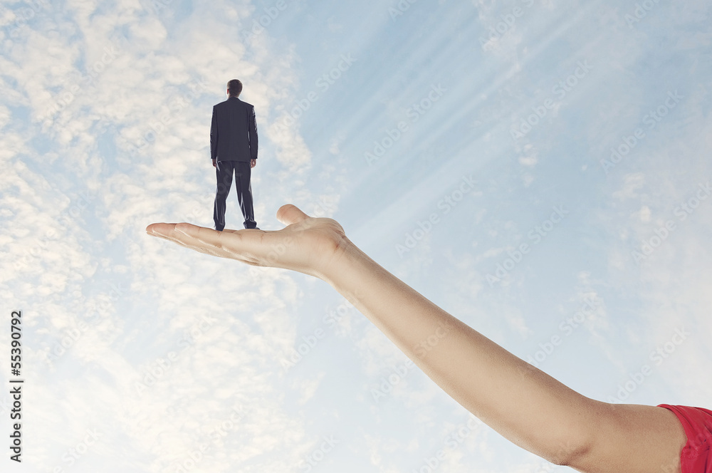 Businessman miniature in hand Businessman miniature in hand