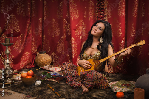 Beautiful woman playing the dombra