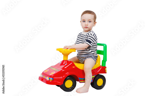 Cute toddler riding in a baby car