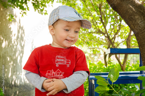 Happy baby in a cap for a walk