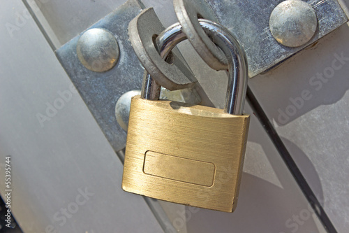 Closed padlock on a metal door photo