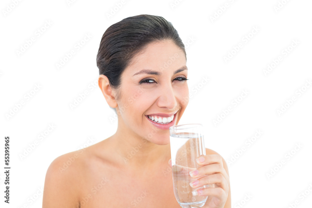 Smiling brunette holding glass of water and looking at camera Smiling brunette holding glass of water and looking at camera