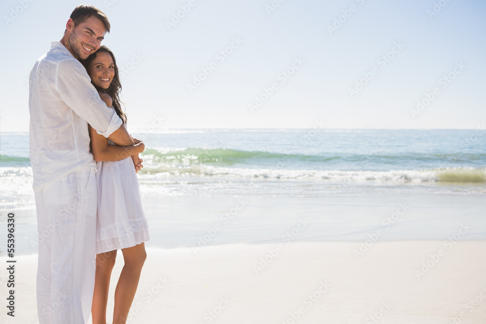Attractive couple hugging and looking at camera Attractive couple hugging and looking at camera