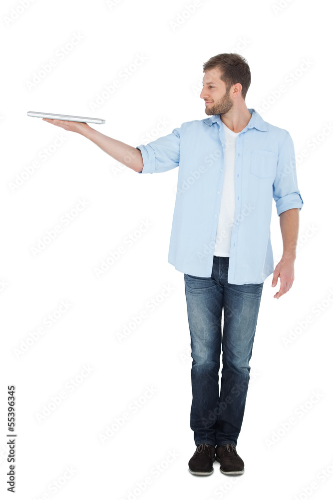 Cheerful model holding laptop on right hand Cheerful model holding laptop on right hand