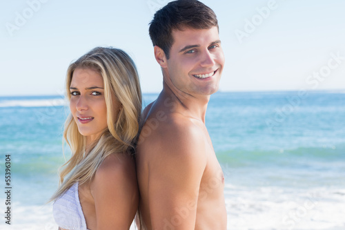 Young happy couple standing back to back © WavebreakmediaMicro