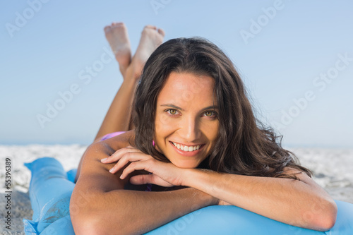 Photos Smiling attractive brunette relaxing on her lilo