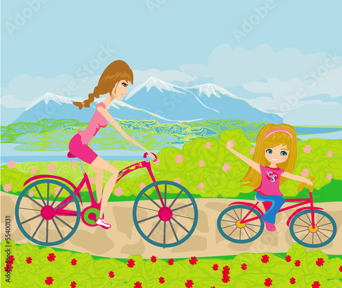Mother and daughter biking in the park