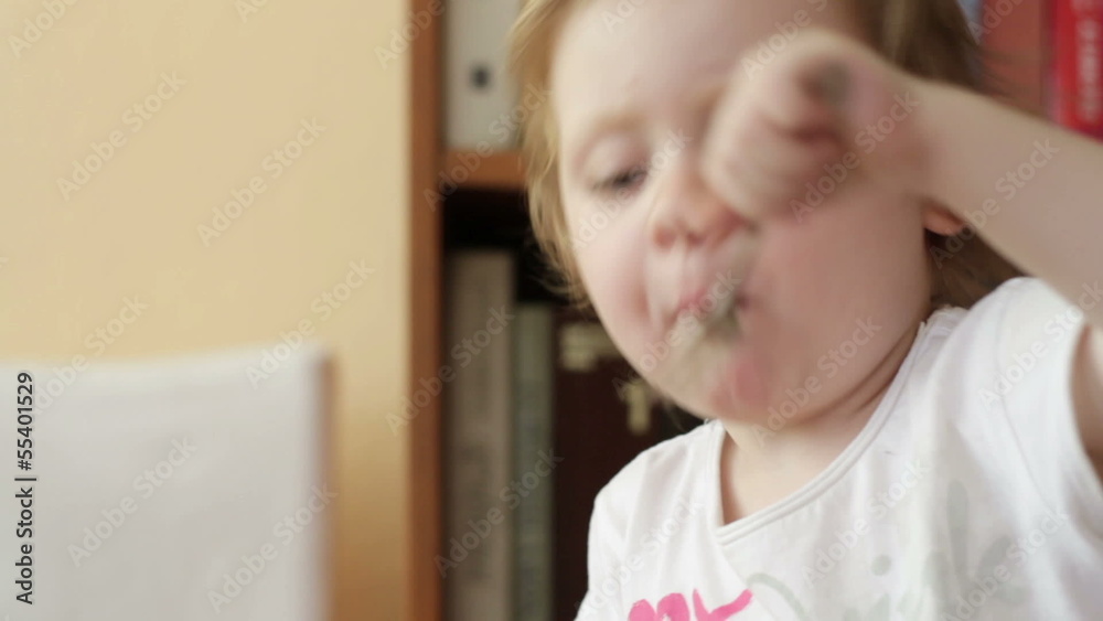 Little girl eats potatoes using fork, close up Little girl eats potatoes using fork, close up