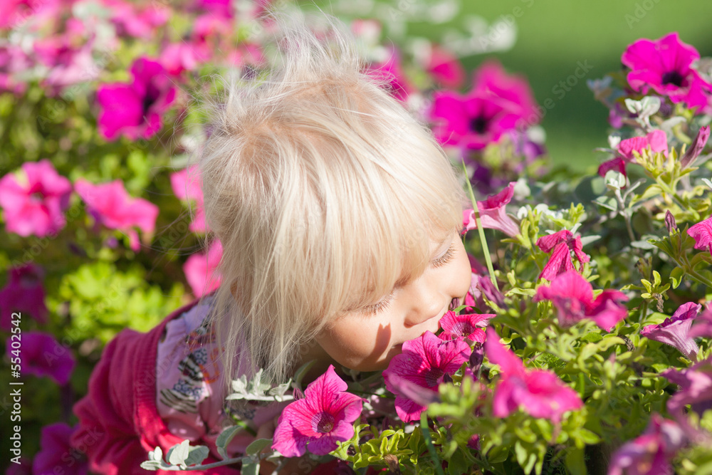 Cute little girl smells flowers Cute little girl smells flowers
