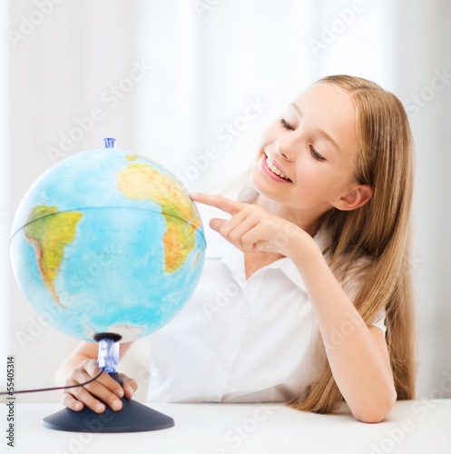 student girl with globe at school