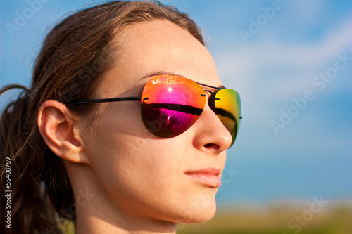 portrait of beauty girl wearing sunglasses outdoors