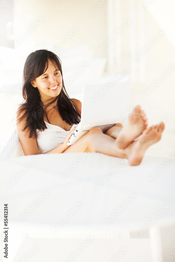 woman relaxing with laptop at home woman relaxing with laptop at home