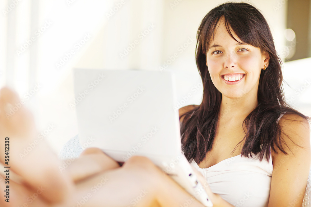 woman relaxing with laptop at home woman relaxing with laptop at home