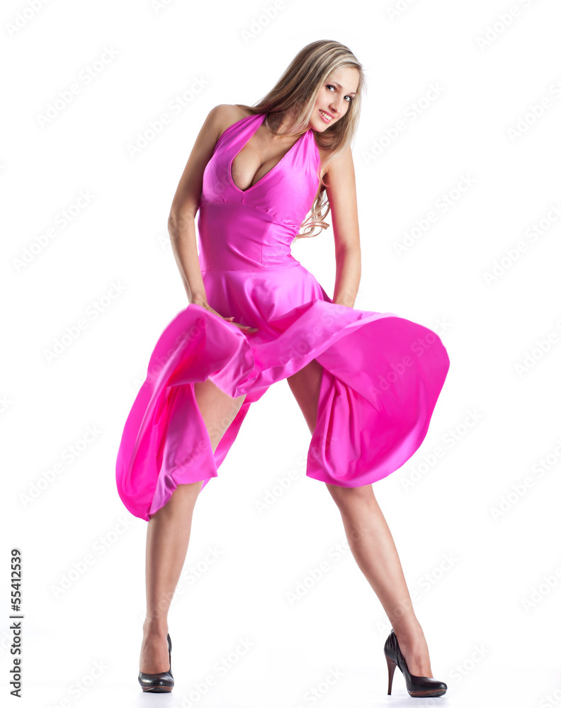 Young woman in a blowing pink dress Young woman in a blowing pink dress