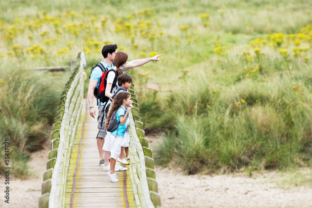 Family Walking Along Wooden Bridge Family Walking Along Wooden Bridge