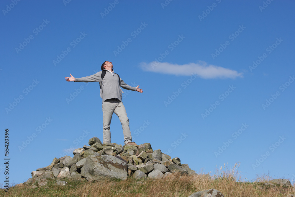Obraz premium Male Walker Standing On Pile Of Rocks