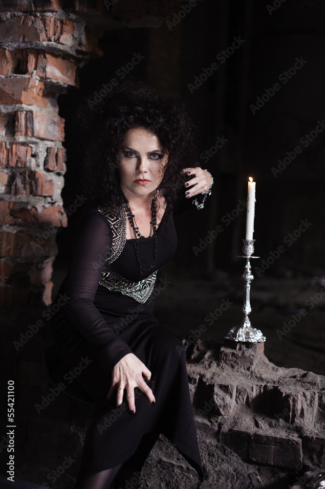 Obraz premium Young sexy witch making the witchcraft in the dungeon