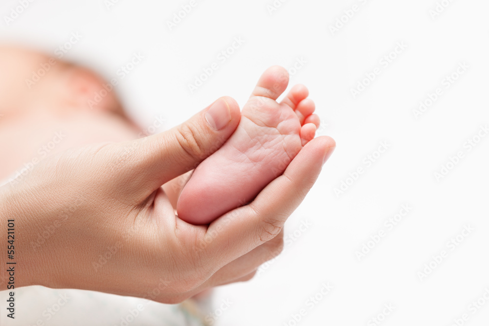 Newborn baby child little foot with heel and toes in mother hand Newborn baby child little foot with heel and toes in mother hand