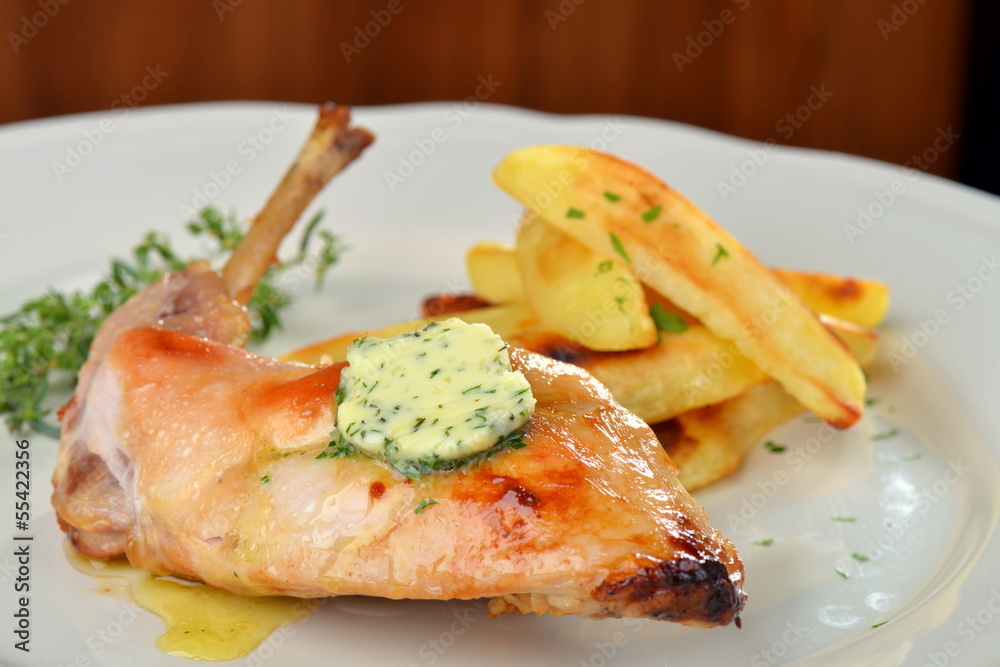 Plate with roasted rabbit leg and potato Plate with roasted rabbit leg and potato
