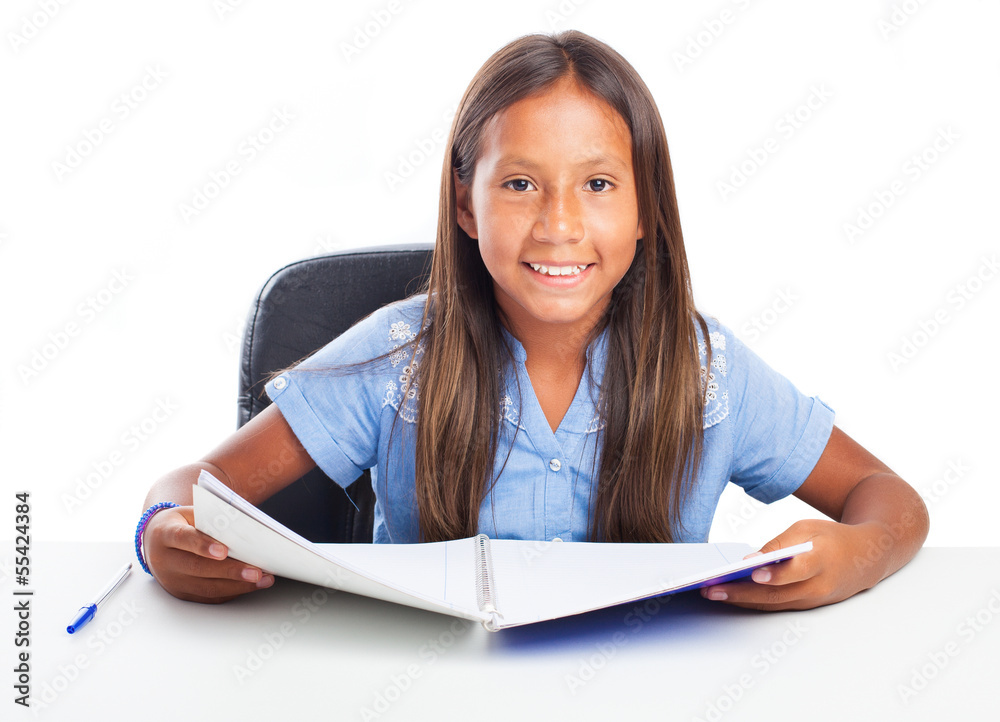 Girl smiling while doing her homeworks on a white background Girl smiling while doing her homeworks on a white background