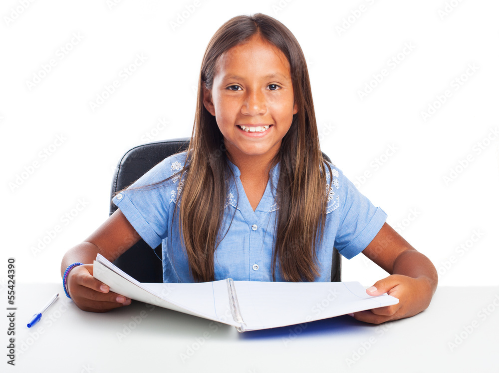 Girl smiling while doing her homeworks on a white background Girl smiling while doing her homeworks on a white background