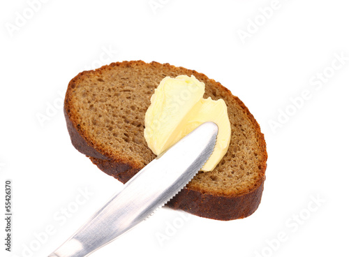 Buttering knife on brown bread.