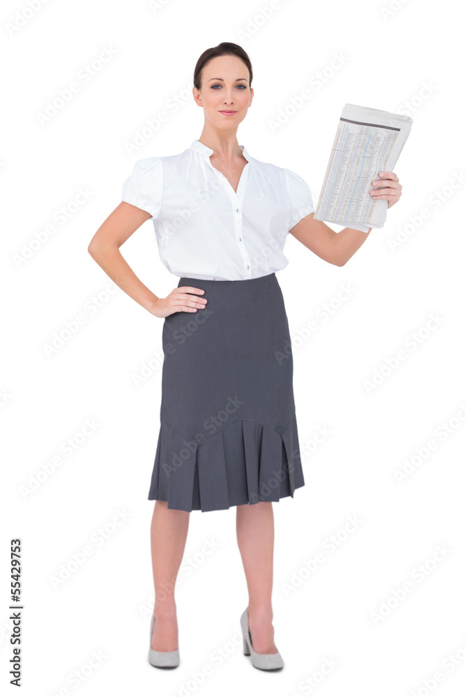 Peaceful stylish businesswoman holding newspaper Peaceful stylish businesswoman holding newspaper