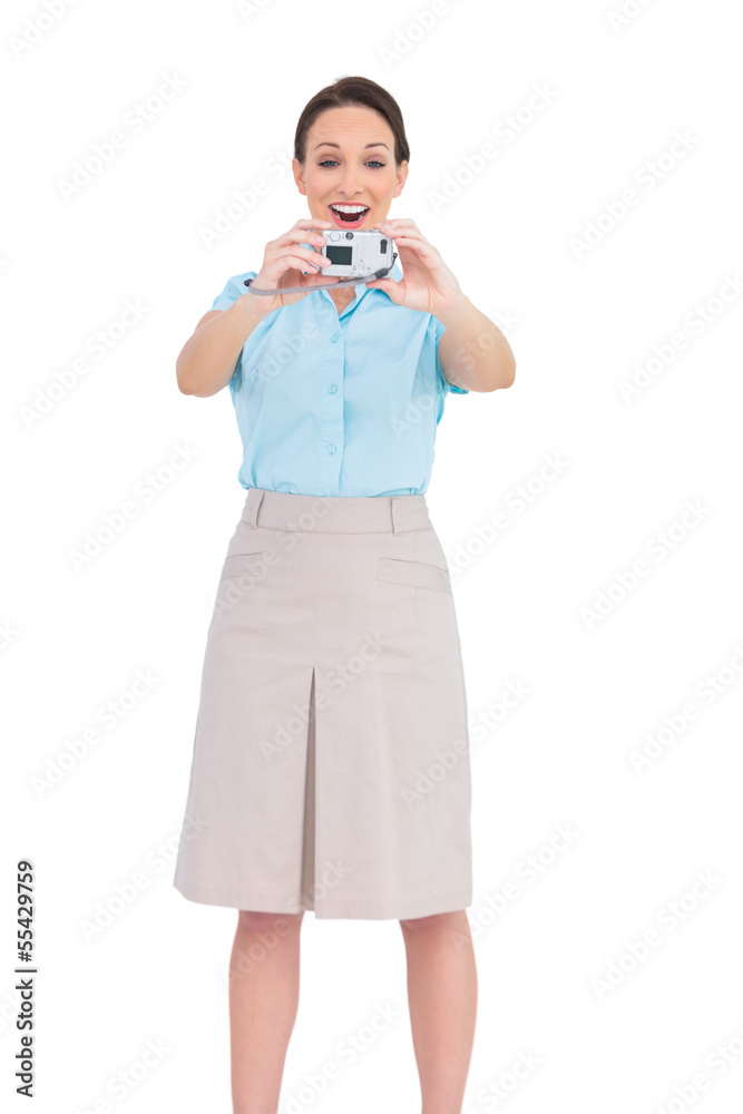 Happy young businesswoman taking picture of herself Happy young businesswoman taking picture of herself