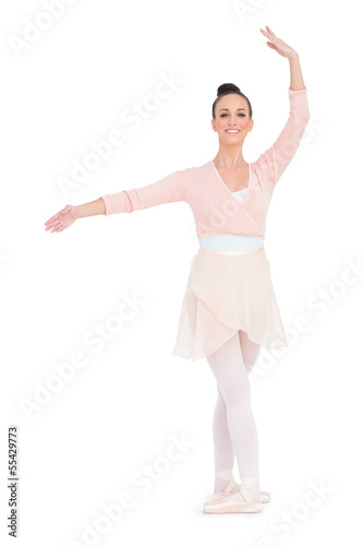 Happy gorgeous ballerina standing in a pose