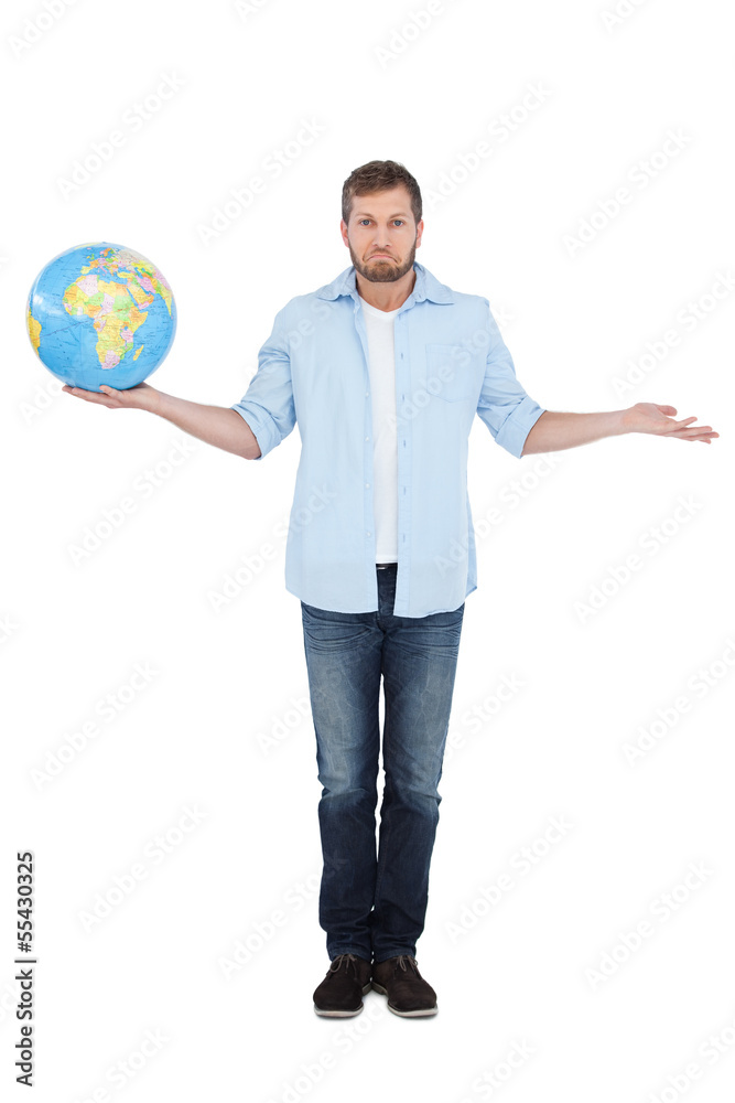 Charming model holding a globe and making faces Charming model holding a globe and making faces