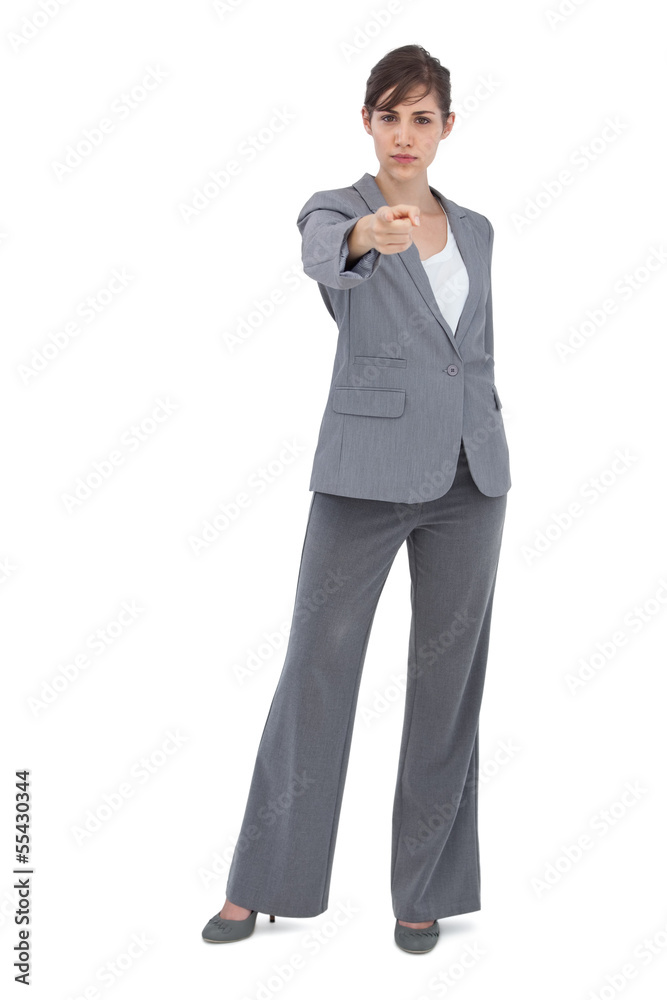 Serious businesswoman pointing at camera Serious businesswoman pointing at camera