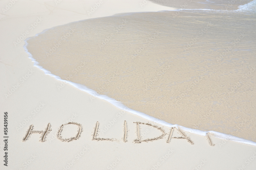 Fototapeta premium HOLIDAY writing on the sandy beach