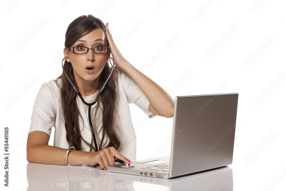 Nervous doctor examined her computer with a stethoscope Nervous doctor examined her computer with a stethoscope