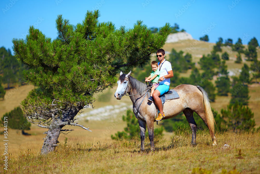 father and son riding together on horse father and son riding together on horse