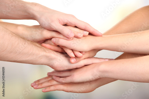 United hands on bright background. Conceptual photo of teamwork © Africa Studio