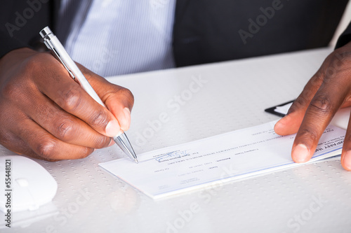 Human Hand Writing On Cheque