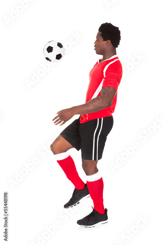 Soccer Player Kicking Football