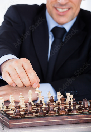 Mature businessman playing chess