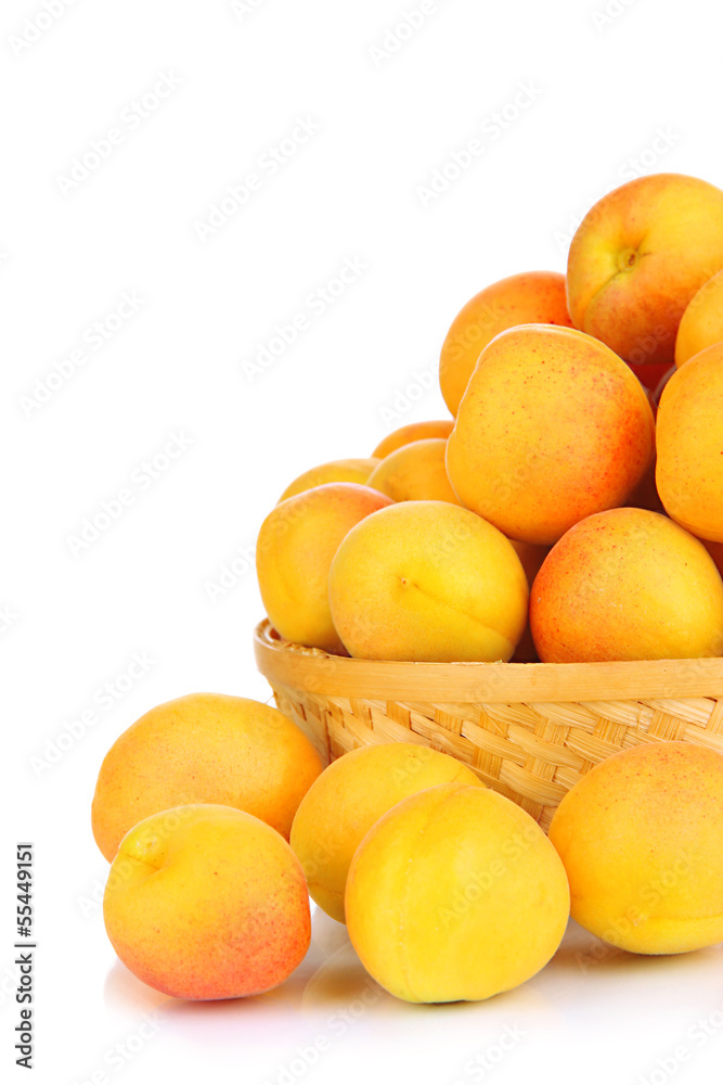 Fresh natural apricot in wicker basket isolated on white Fresh natural apricot in wicker basket isolated on white