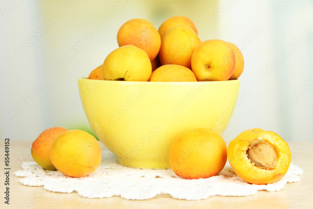 Fresh natural apricot in bowl on table in kitchen Fresh natural apricot in bowl on table in kitchen