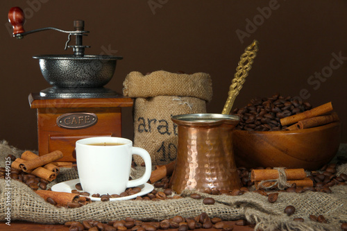 Metal turk and coffee cup on dark background © Africa Studio