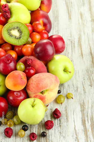 Assortment of juicy fruits, on wooden background
