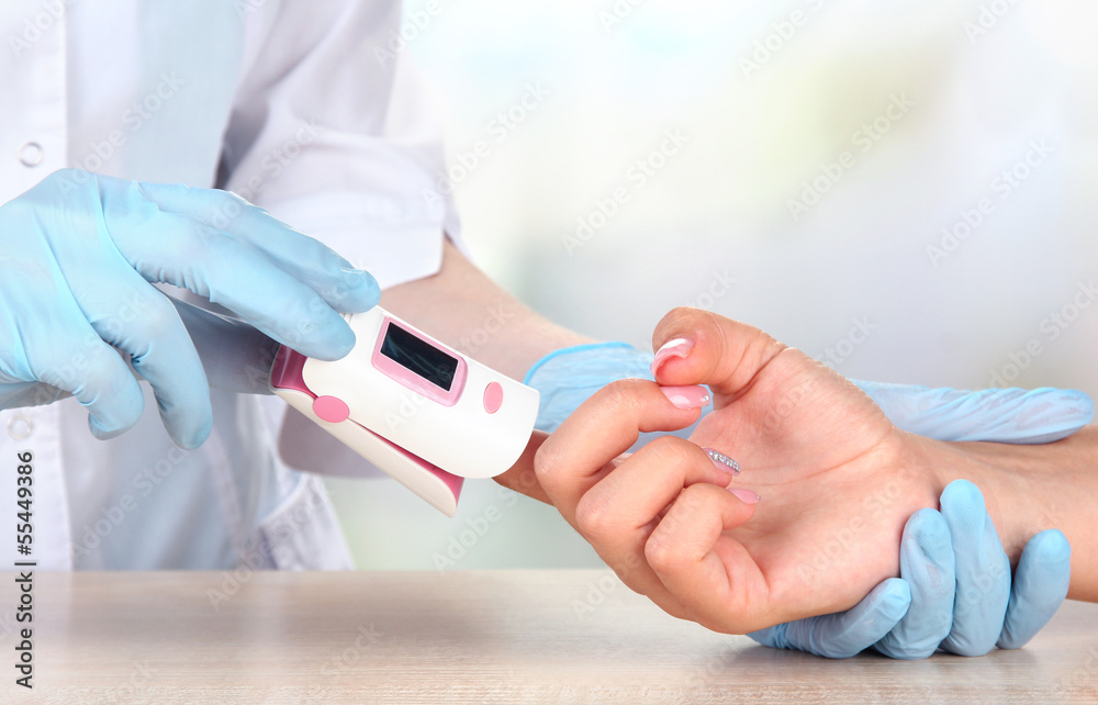 Doctor measuring pulse rate and oxygen levels, Doctor measuring pulse rate and oxygen levels,