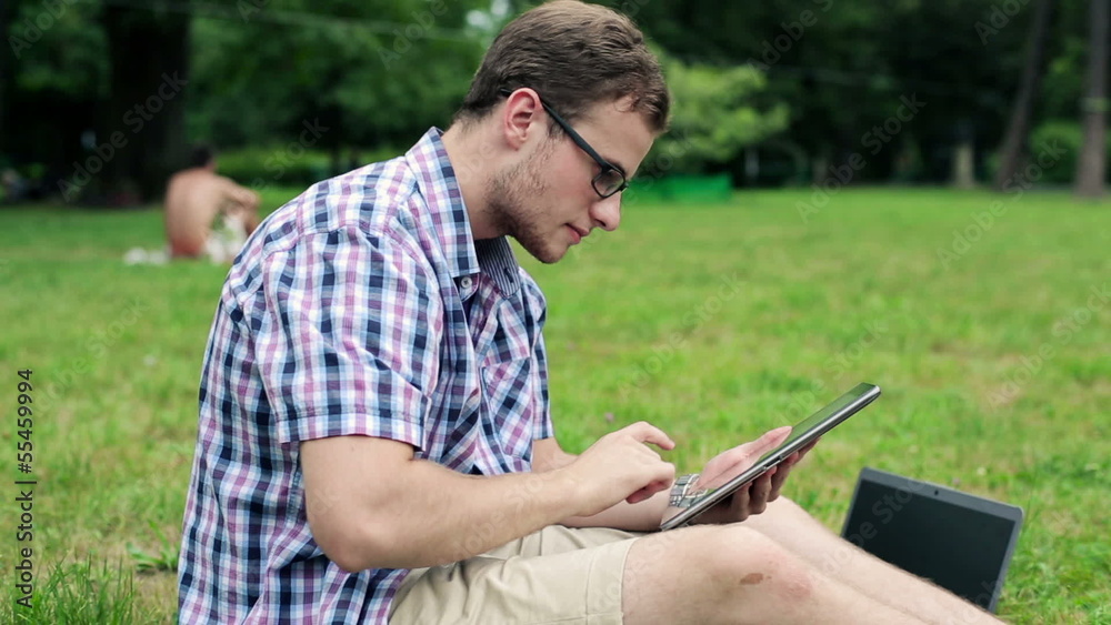 Young male student with tablet computer in the park Young male student with tablet computer in the park