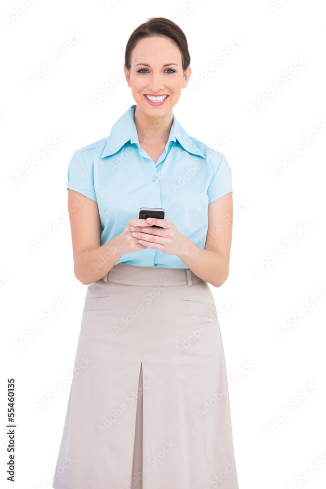 Happy classy young businesswoman sending text message Happy classy young businesswoman sending text message