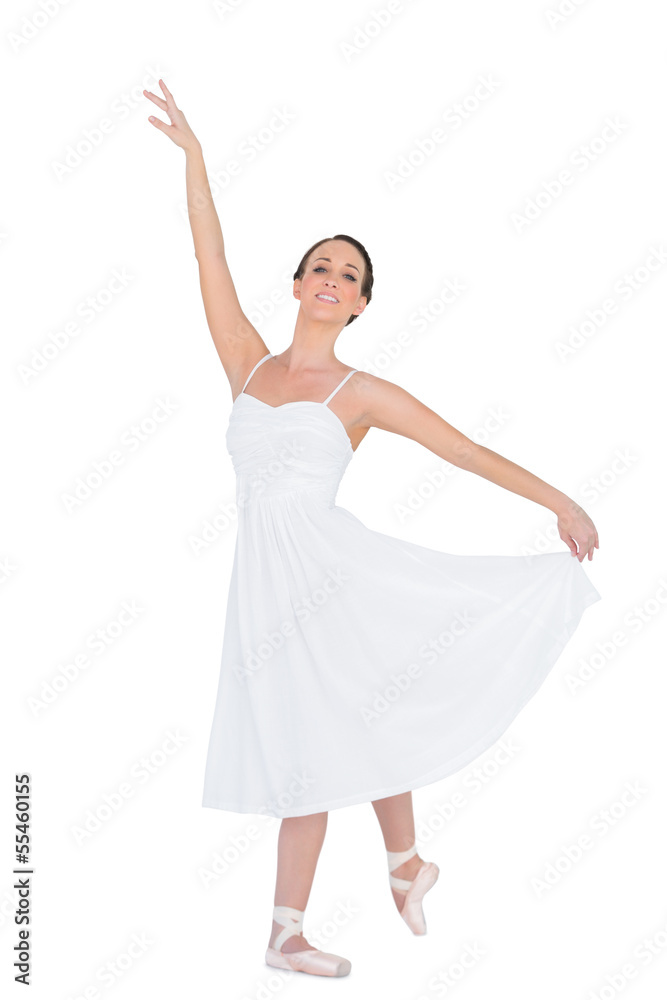 Smiling young ballet dancer posing with her leg back