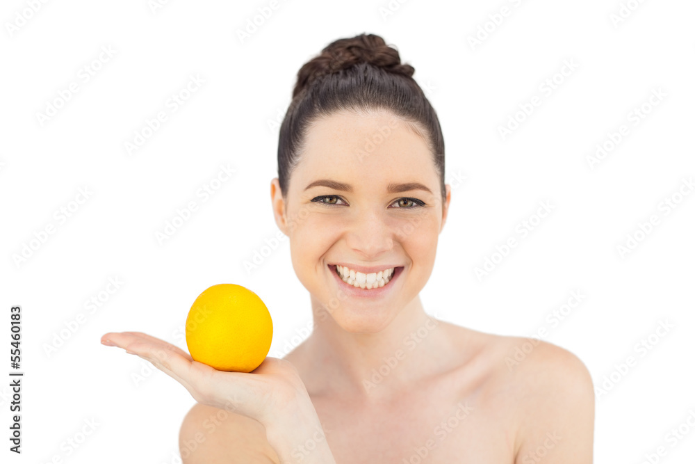 Smiling pretty model holding orange Smiling pretty model holding orange