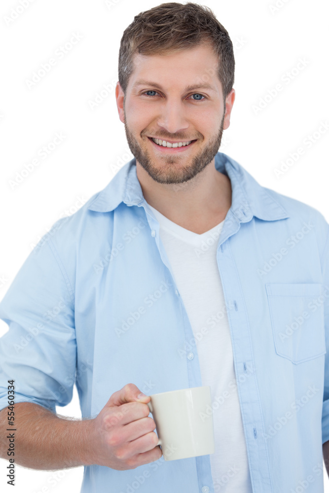 Smiling young model holding a mug Smiling young model holding a mug
