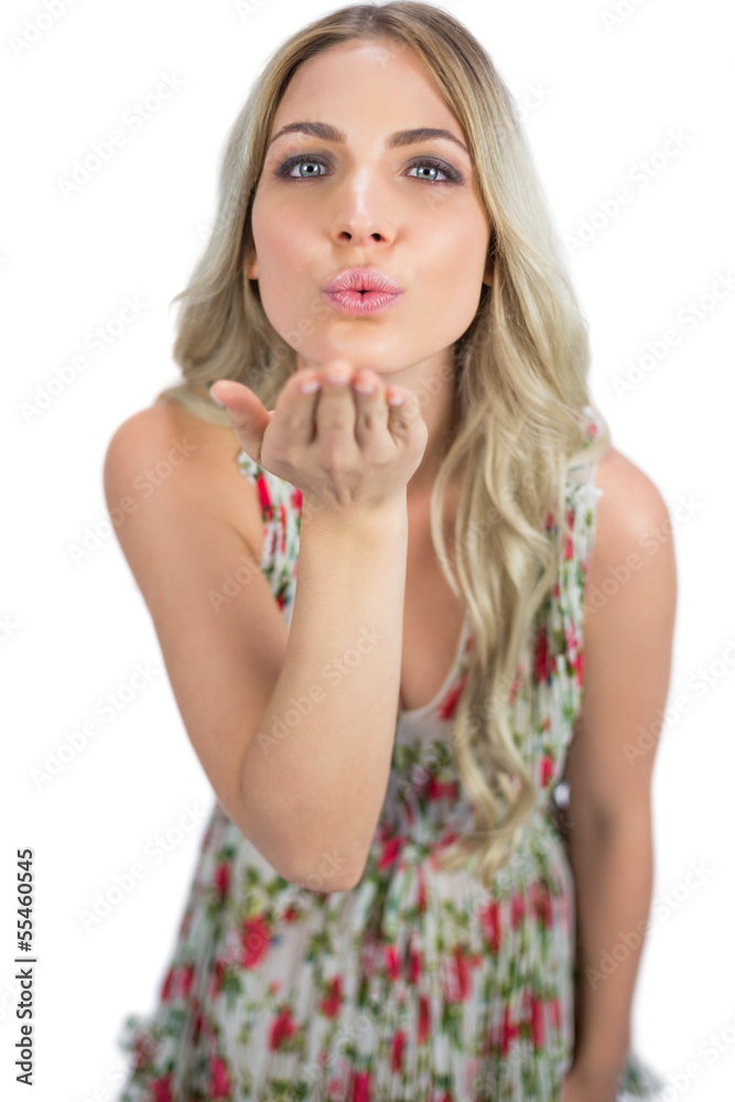 Seductive blonde wearing flowered dress sending a kiss Seductive blonde wearing flowered dress sending a kiss