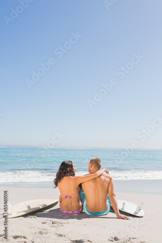 Loving young couple sitting with their surfboards © WavebreakmediaMicro